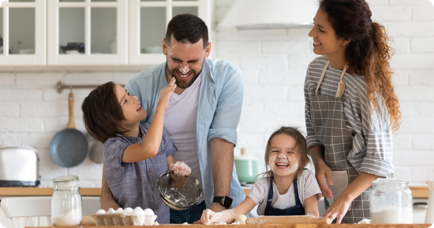 Parents and children happily baking together in Kitchen as a WiFi Motion Home Insights