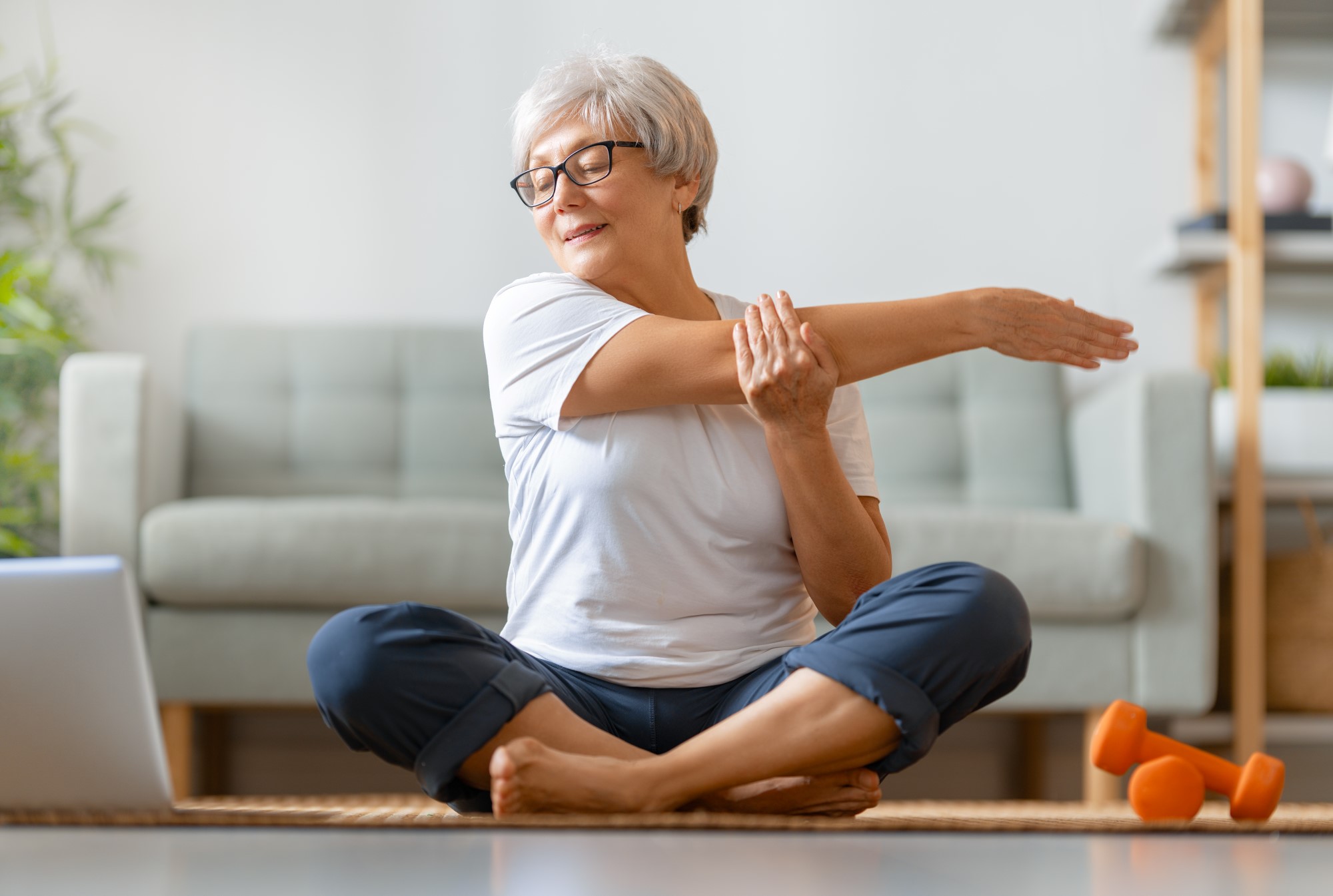 Senior woman stretching while doing yoga